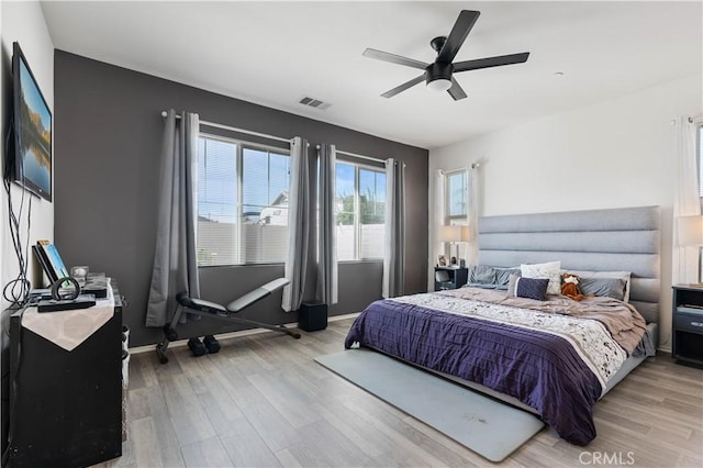 bedroom with ceiling fan and light hardwood / wood-style flooring