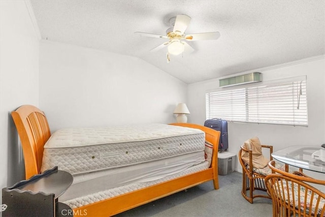 bedroom with carpet, a textured ceiling, ceiling fan, and lofted ceiling