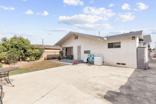 back of property with a patio and washer / clothes dryer