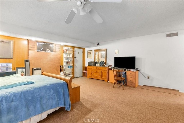 bedroom featuring ceiling fan, carpet floors, and a textured ceiling