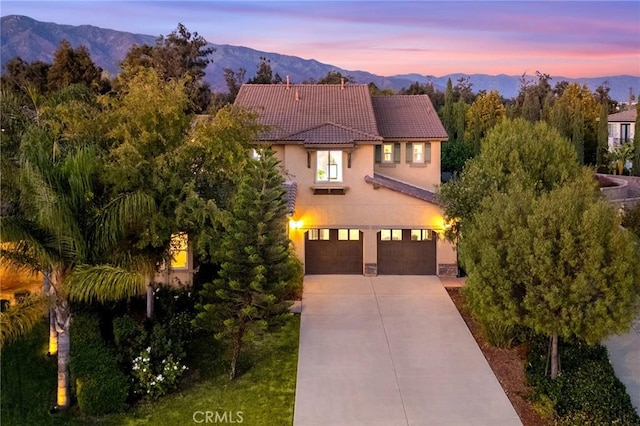 mediterranean / spanish home with a mountain view and a garage