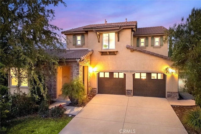 mediterranean / spanish-style home featuring a garage