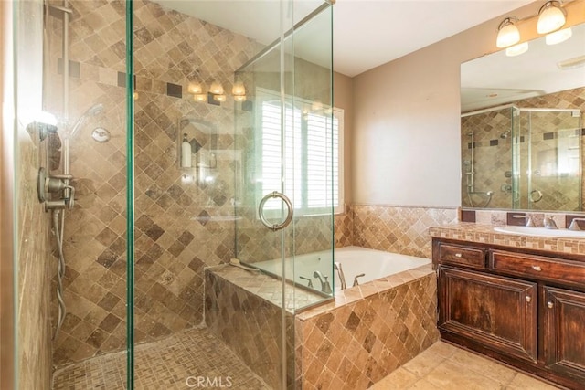 bathroom featuring tile patterned floors, plus walk in shower, and vanity