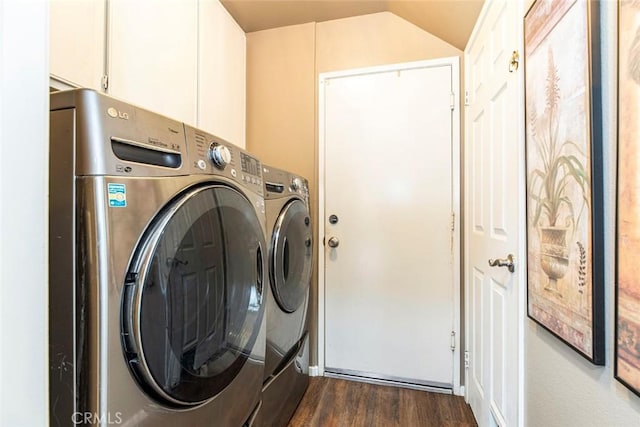 laundry area featuring washer and dryer, dark hardwood / wood-style flooring, and cabinets