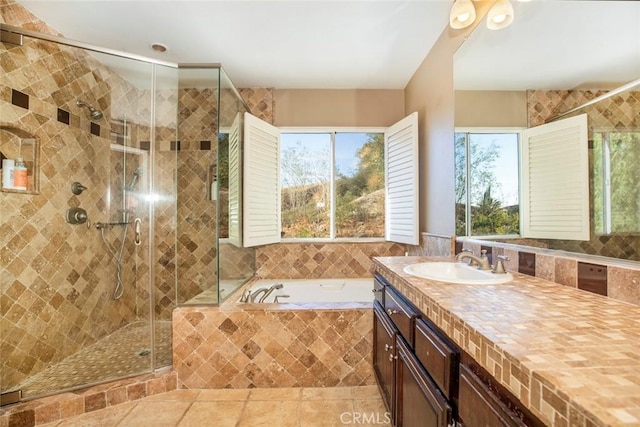 bathroom with tile patterned floors, separate shower and tub, and vanity