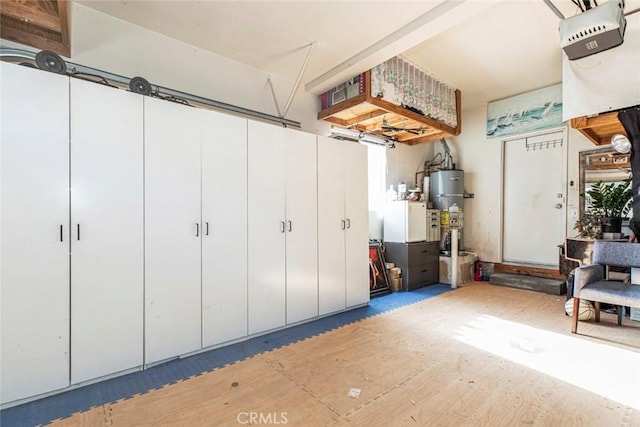 garage featuring secured water heater and a garage door opener