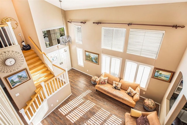 living room featuring hardwood / wood-style flooring and a high ceiling