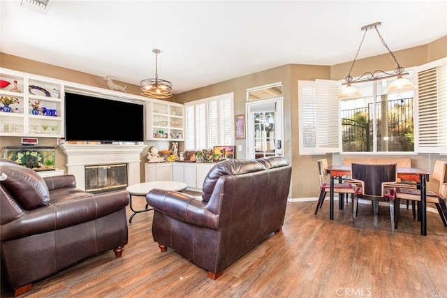 living room with wood-type flooring and an inviting chandelier