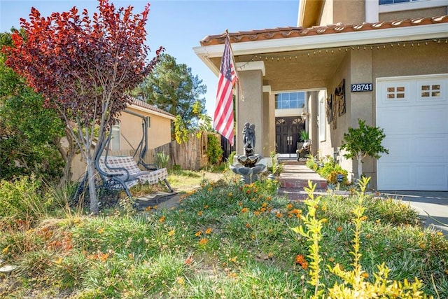 view of exterior entry with a garage