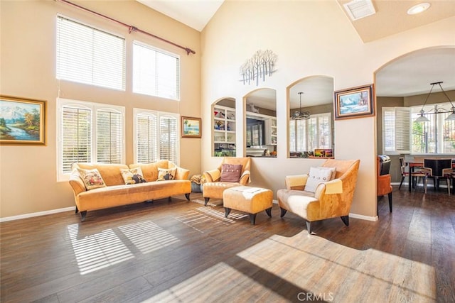 interior space with high vaulted ceiling and dark wood-type flooring