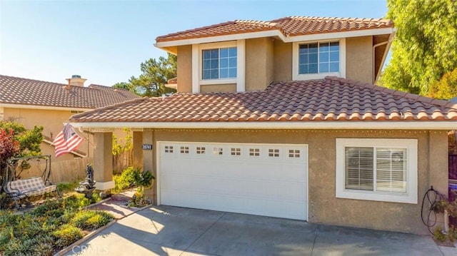 mediterranean / spanish house with a garage