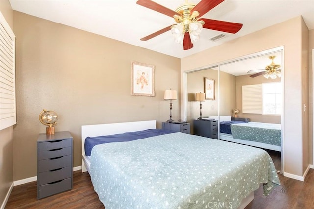 bedroom with dark hardwood / wood-style flooring, a closet, and ceiling fan