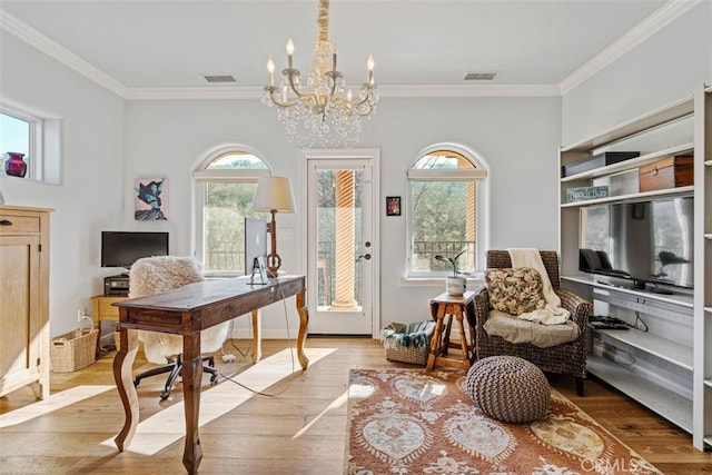 office space with an inviting chandelier, ornamental molding, and light wood-type flooring