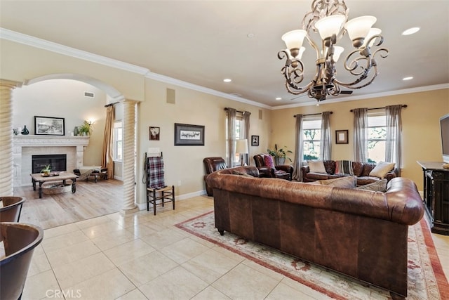 tiled living room featuring ornate columns and ornamental molding