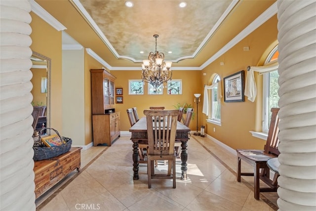 tiled dining space featuring an inviting chandelier, a tray ceiling, and ornamental molding