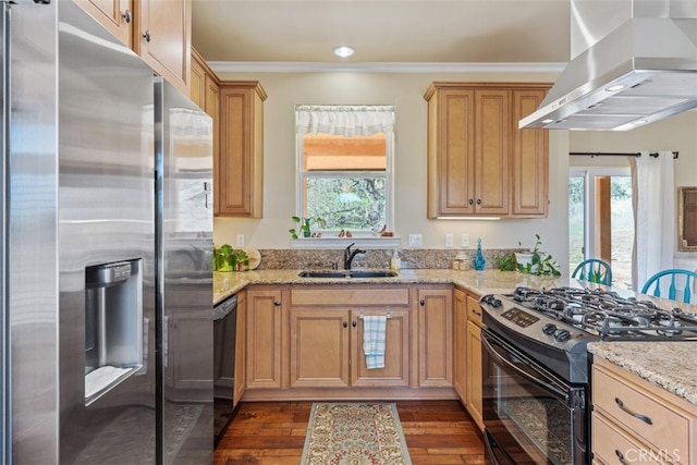 kitchen with light stone countertops, black appliances, dark wood-type flooring, sink, and island range hood