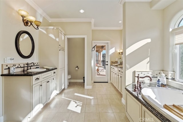 bathroom with toilet, ornamental molding, tile patterned floors, vanity, and a bathing tub