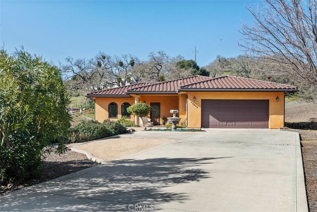 mediterranean / spanish-style home featuring a garage