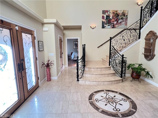 entrance foyer with french doors and light tile patterned flooring