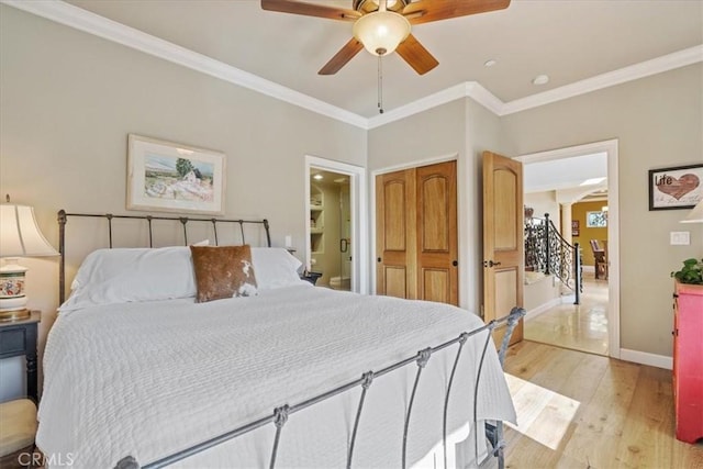 bedroom featuring ceiling fan, ornamental molding, and light hardwood / wood-style floors