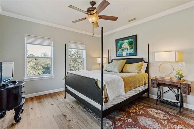 bedroom with light hardwood / wood-style flooring, ceiling fan, and ornamental molding