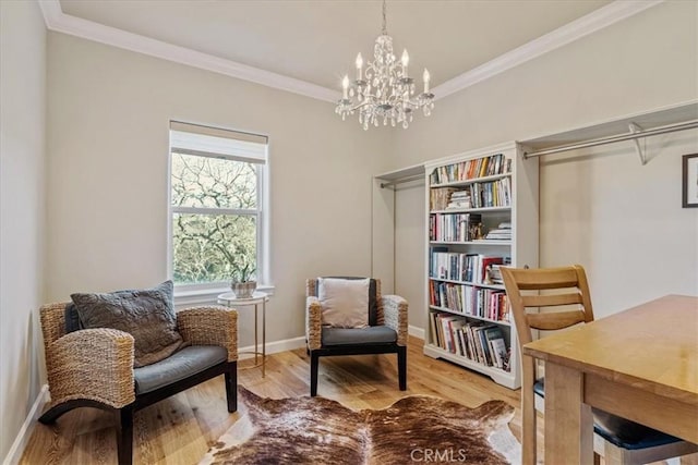 living area featuring hardwood / wood-style flooring, an inviting chandelier, and ornamental molding