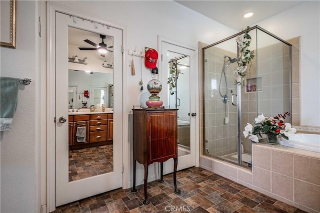 bathroom featuring vanity, ceiling fan, and separate shower and tub