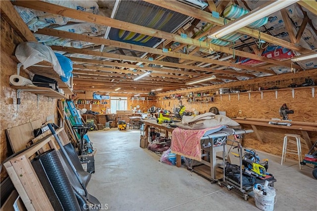 misc room with a workshop area and concrete flooring