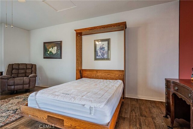 bedroom with dark wood-type flooring