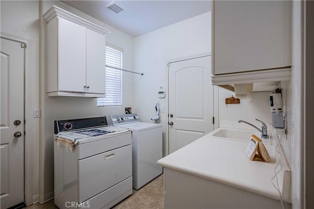 laundry room with separate washer and dryer, sink, and cabinets