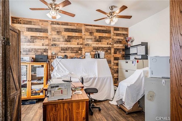 office area featuring hardwood / wood-style floors, ceiling fan, and wooden walls