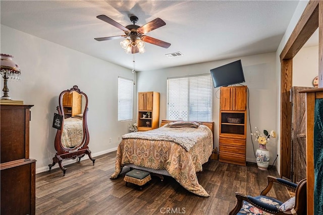 bedroom with ceiling fan and dark hardwood / wood-style floors