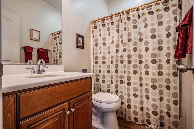 bathroom with a shower with curtain, vanity, hardwood / wood-style flooring, and toilet