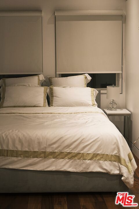 bedroom featuring dark wood-type flooring