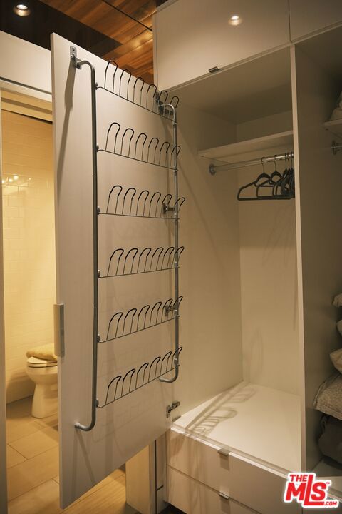 bathroom featuring toilet, walk in shower, and wood ceiling