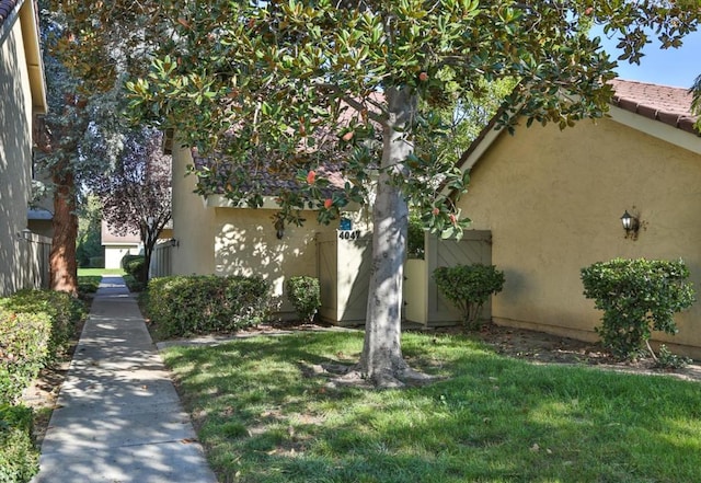 view of side of home with a lawn