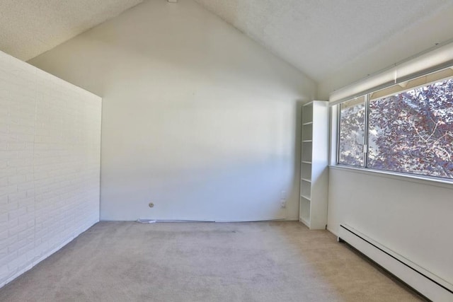 spare room with light carpet, a baseboard radiator, vaulted ceiling, and brick wall