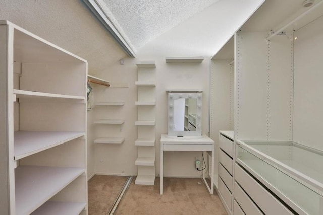 walk in closet featuring light carpet