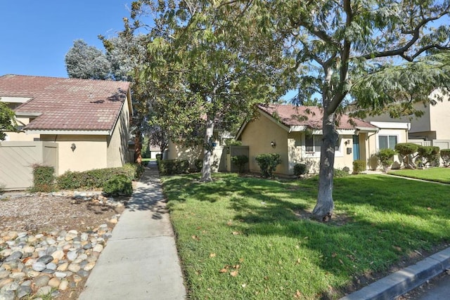 view of side of home with a yard