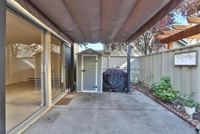 view of patio / terrace featuring a storage shed, grilling area, and a baseboard radiator