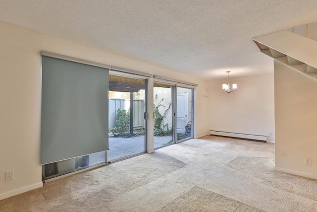 carpeted spare room featuring a chandelier, a textured ceiling, and a baseboard heating unit