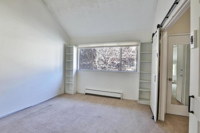 interior space featuring baseboard heating, a barn door, light carpet, and lofted ceiling