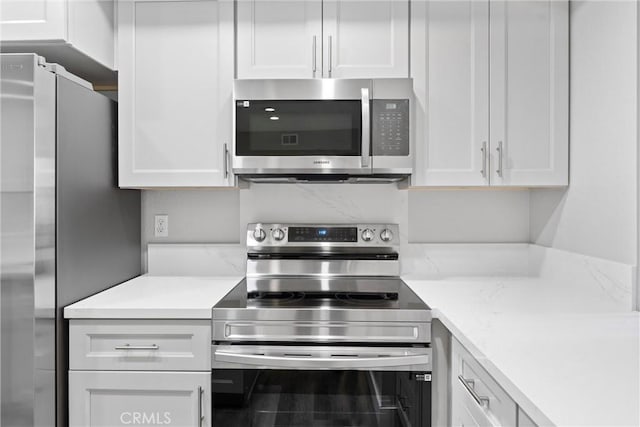 kitchen with white cabinetry and appliances with stainless steel finishes