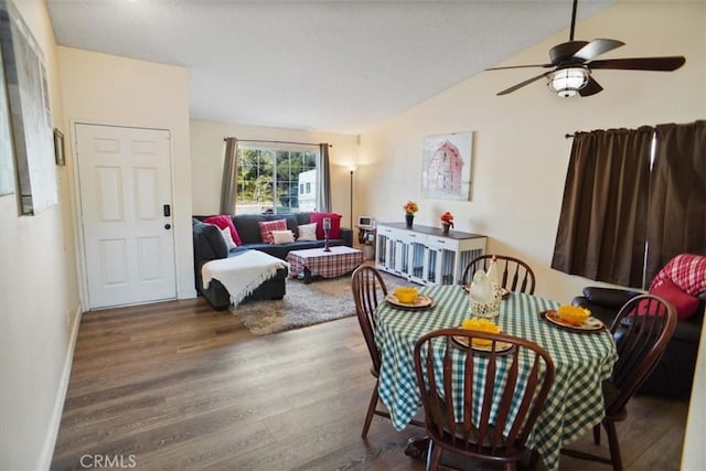 living room with ceiling fan, hardwood / wood-style floors, and vaulted ceiling