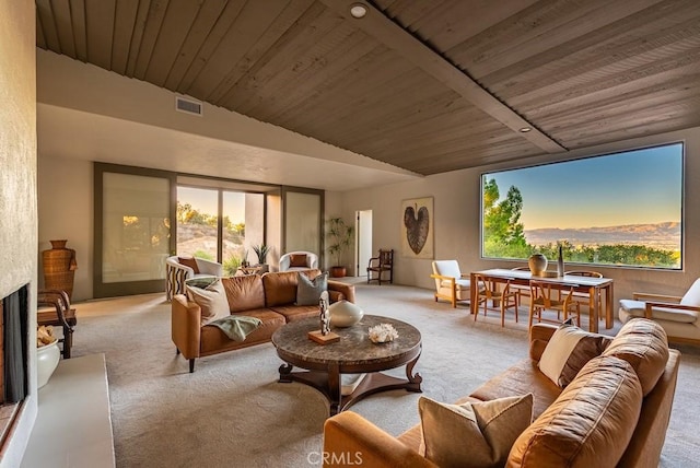 interior space featuring a large fireplace, wooden ceiling, plenty of natural light, and lofted ceiling