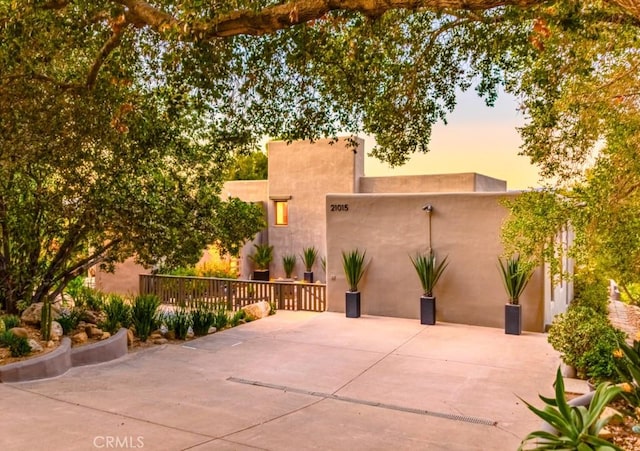 view of patio terrace at dusk