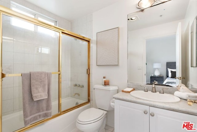 full bathroom featuring toilet, vanity, and combined bath / shower with glass door