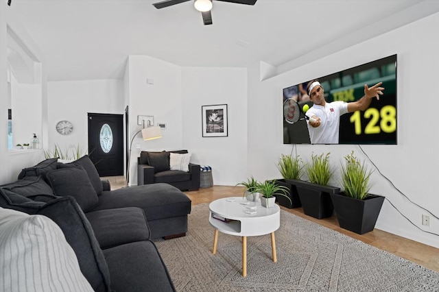 living room with hardwood / wood-style flooring, ceiling fan, and lofted ceiling