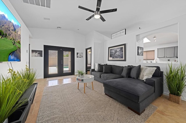 living room with lofted ceiling, ceiling fan, and french doors