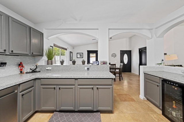 kitchen with gray cabinets, wine cooler, and kitchen peninsula